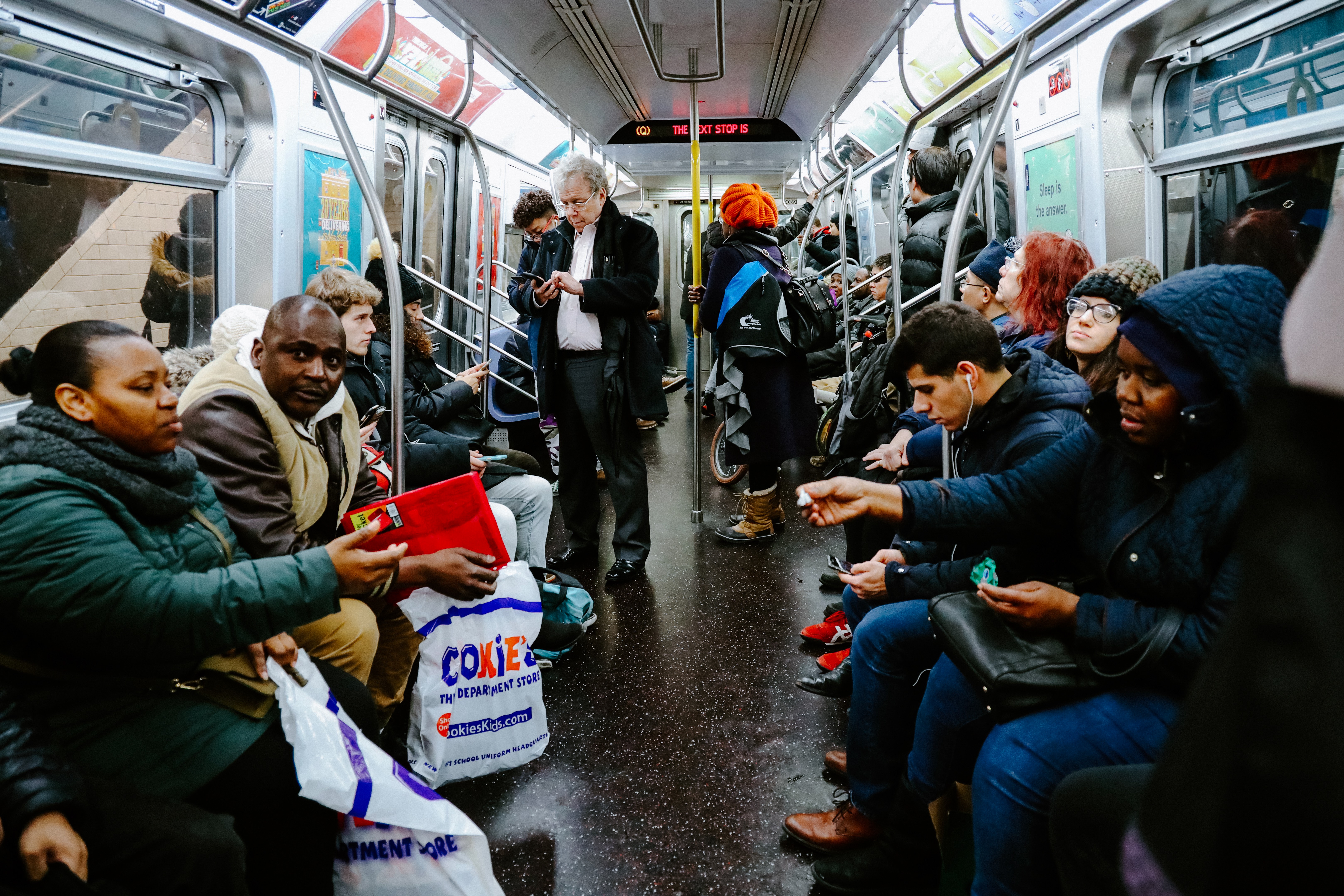 People sitting in crowded NYC subway
